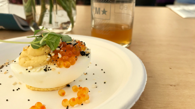 A deviled egg with smoked trout roe, everything spice, and purple shiso paired with Uinta Brewing’s Alpenglow wild ale.